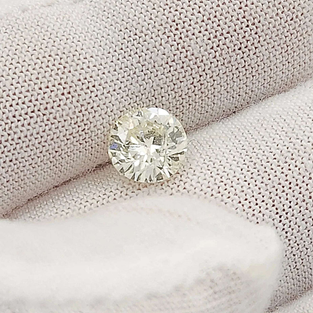 1.40 Carat I2, Color M, Round Brilliant Cut Natural Diamond.