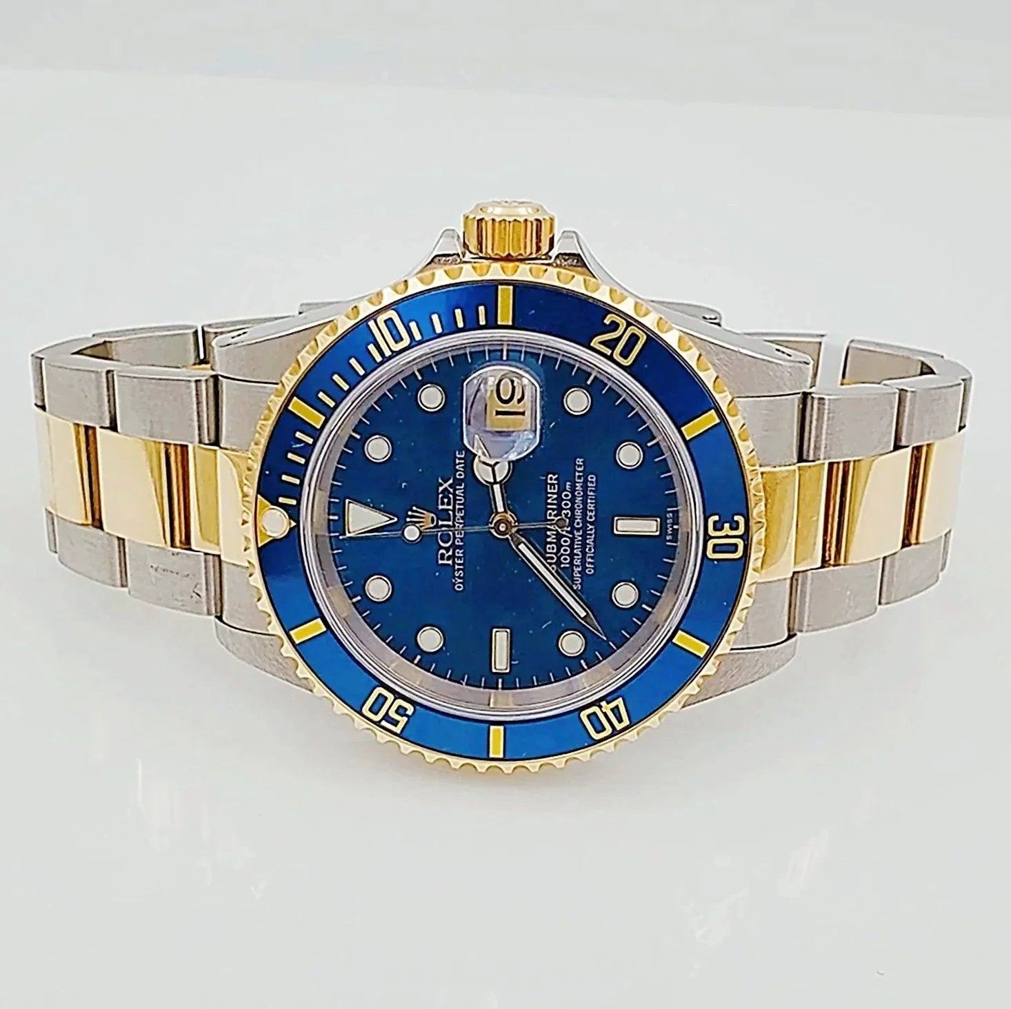 1991 Men's Rolex 40mm Submariner Oyster Perpetual Two Tone 18K Yellow Gold / Stainless Steel Watch with Blue Dial and Blue Bezel. (Pre-Owned 16613)