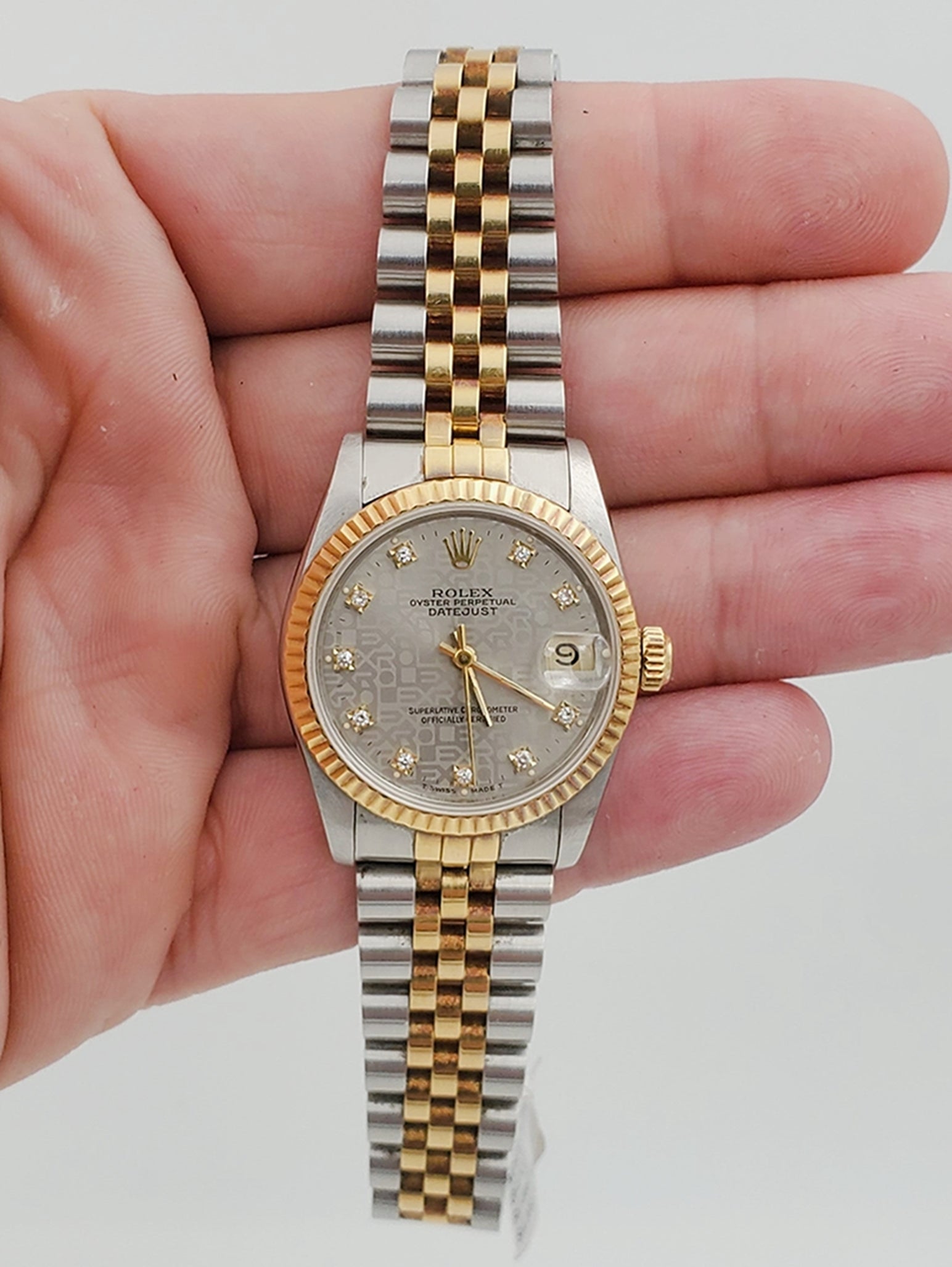 Ladies Rolex Midsize 31mm DateJust Two Tone 18K Yellow Gold / Stainless Steel Wristwatch w/ Silver Diamond Dial & Fluted Bezel. (Pre-Owned 682735)