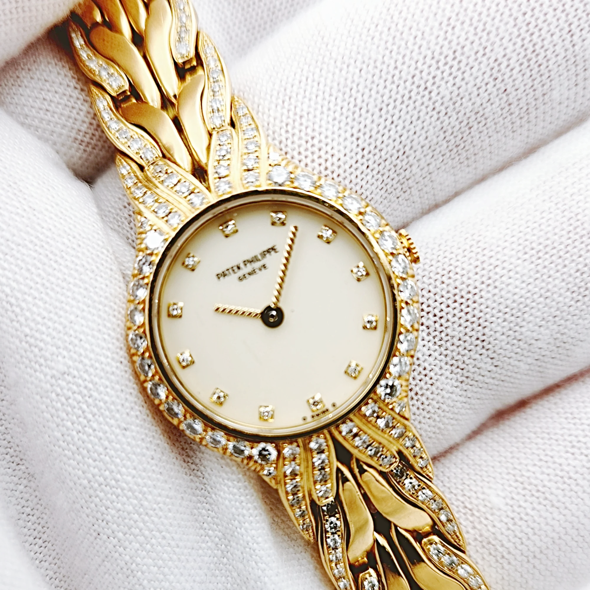 Ladies Patek Philippe 23mm La Flamme 18K Yellow Gold Watch with Cream Diamond Dial and Diamond Bezel. (Pre-Owned Model 4816/3)