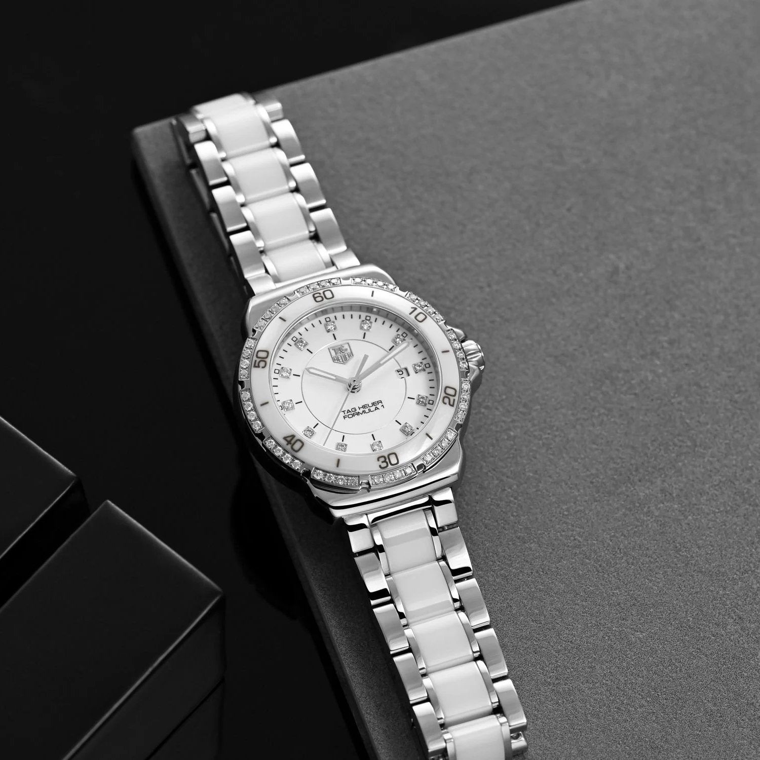 Ladies TAG Heuer 32mm Formula 1 Ceramic Watch with White Diamond Dial and Diamond Bezel. (Pre-Owned WAH1313)