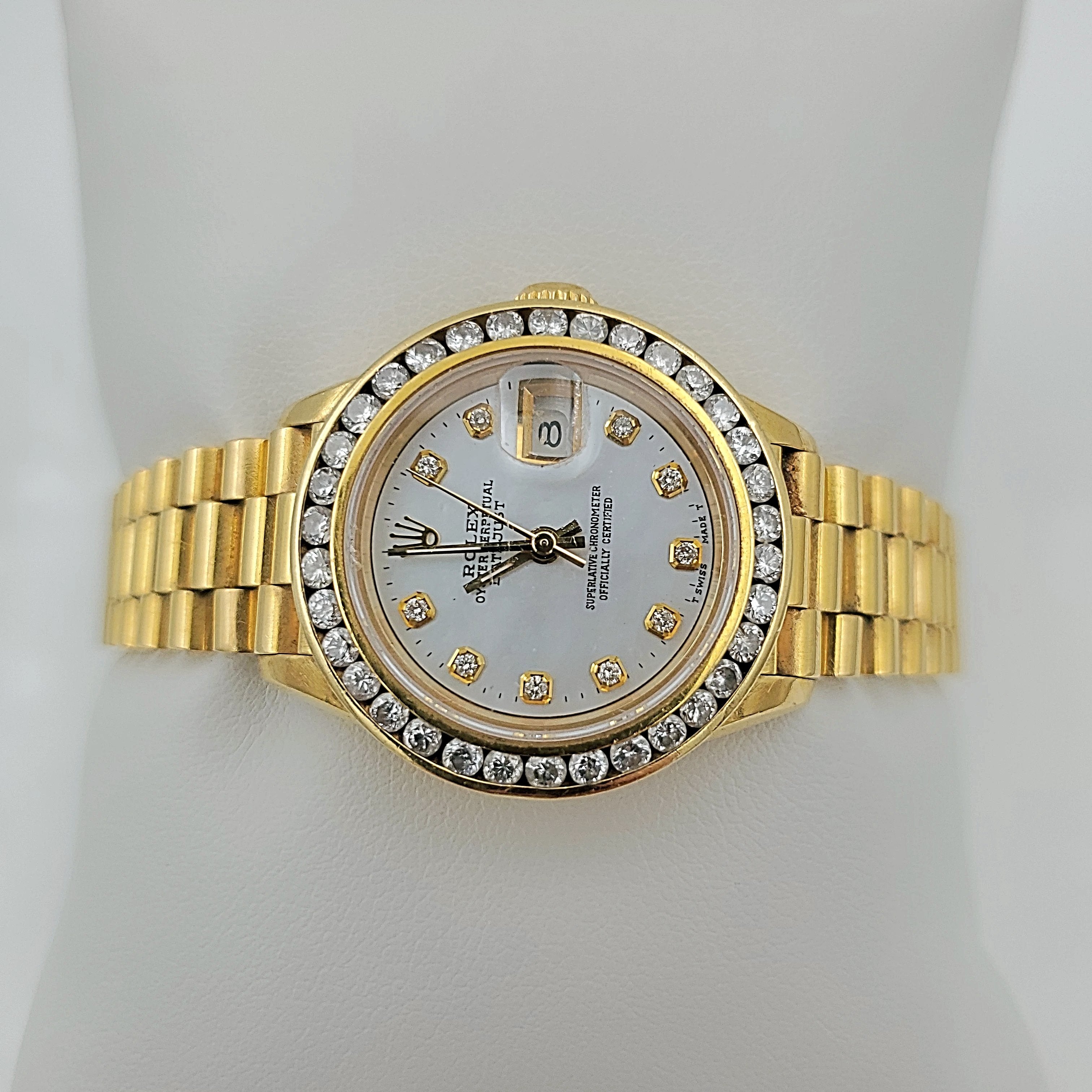 Ladies Rolex 26mm Presidential 18K Yellow Gold Watch with Mother of Pearl Diamond Dial and Diamond Bezel. (Pre-Owned)