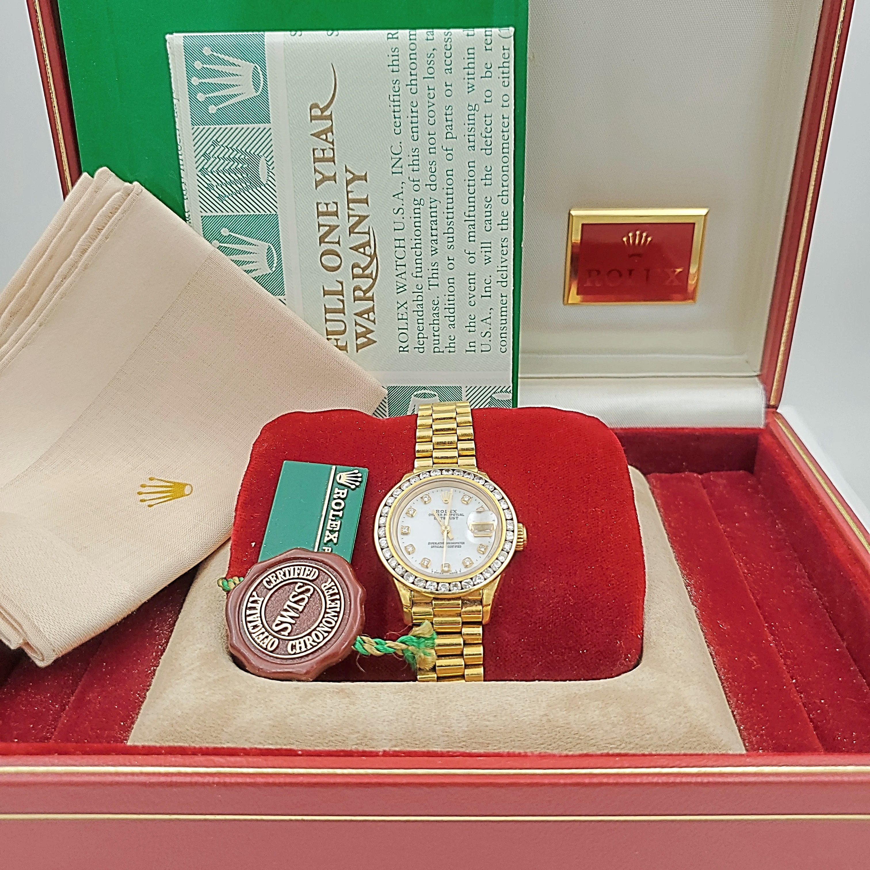 Ladies Rolex 26mm Presidential 18K Yellow Gold Watch with Mother of Pearl Diamond Dial and Diamond Bezel. (Pre-Owned)