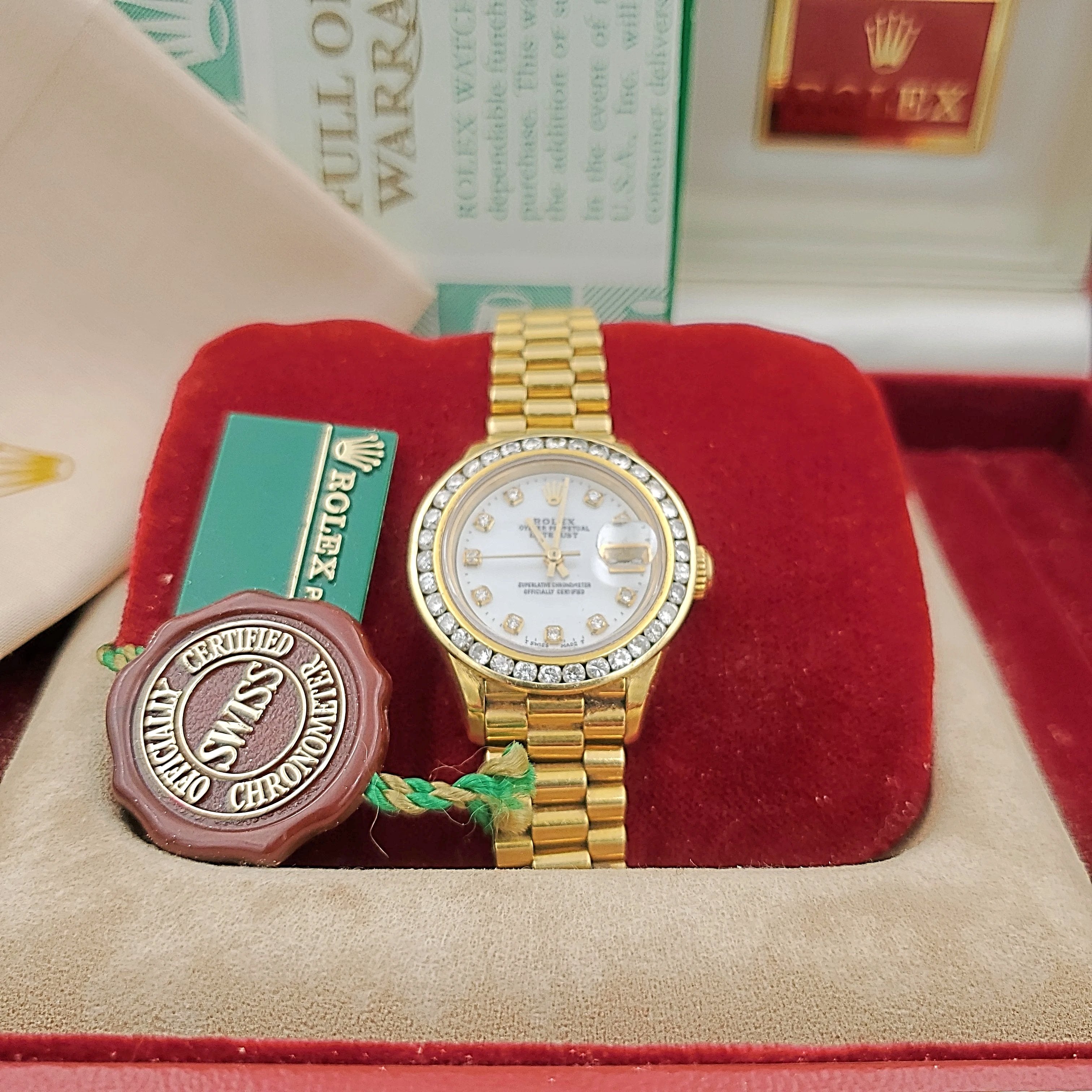 Ladies Rolex 26mm Presidential 18K Yellow Gold Watch with Mother of Pearl Diamond Dial and Diamond Bezel. (Pre-Owned)