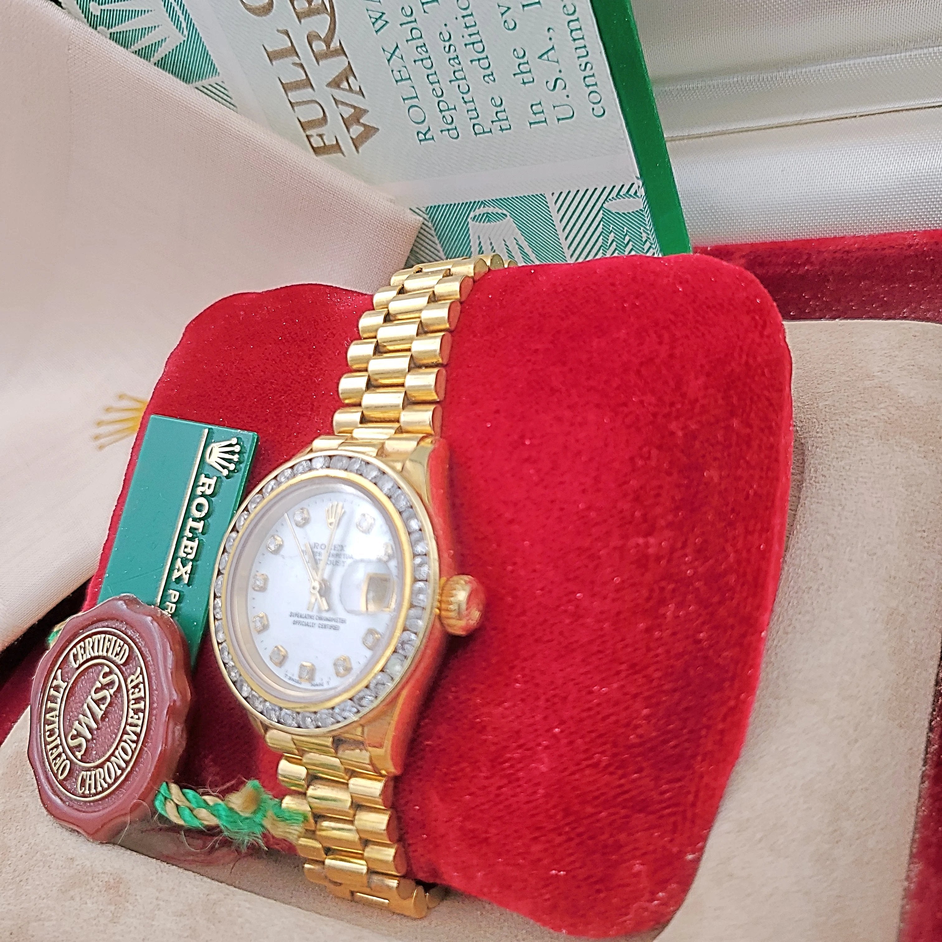 Ladies Rolex 26mm Presidential 18K Yellow Gold Watch with Mother of Pearl Diamond Dial and Diamond Bezel. (Pre-Owned)