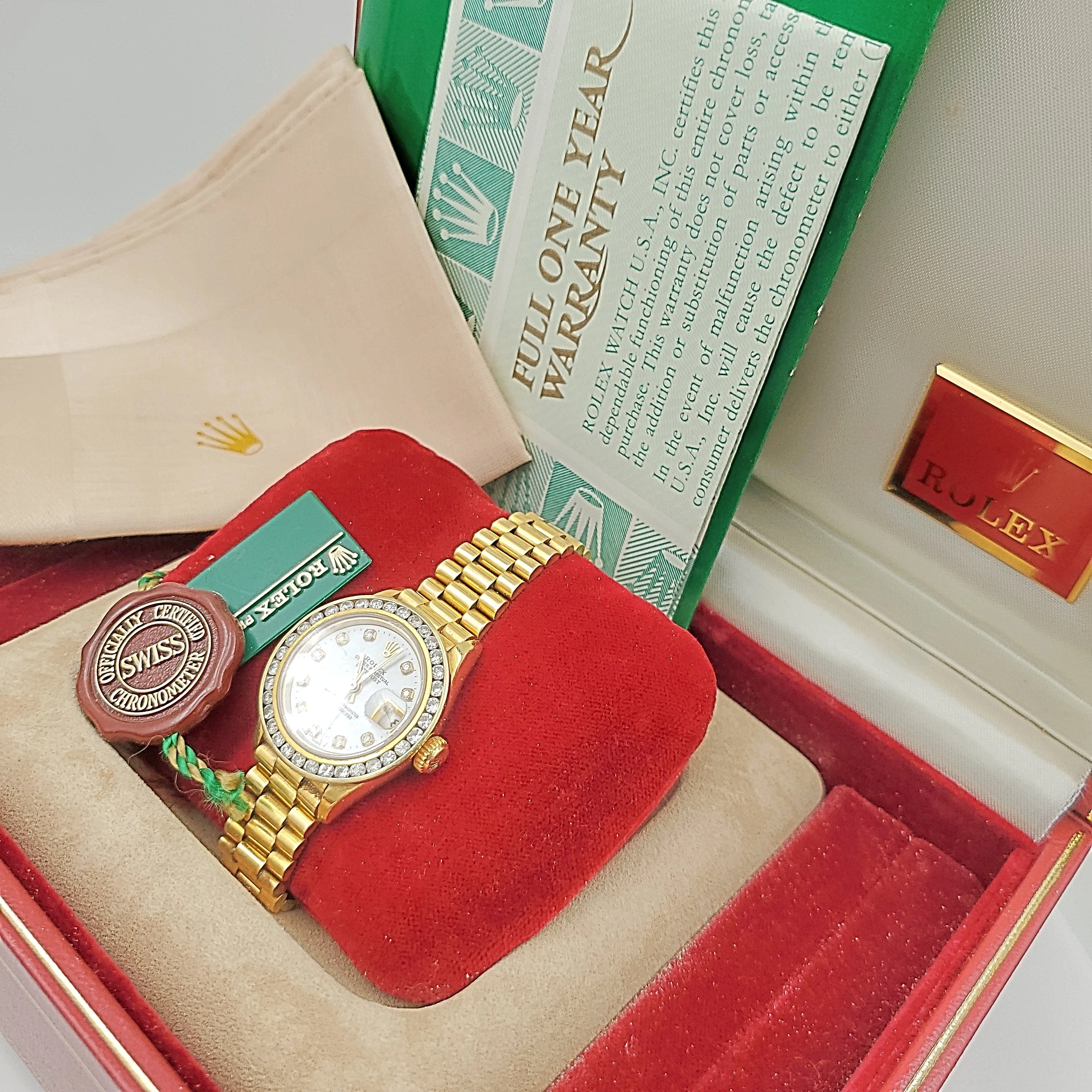 Ladies Rolex 26mm Presidential 18K Yellow Gold Watch with Mother of Pearl Diamond Dial and Diamond Bezel. (Pre-Owned)