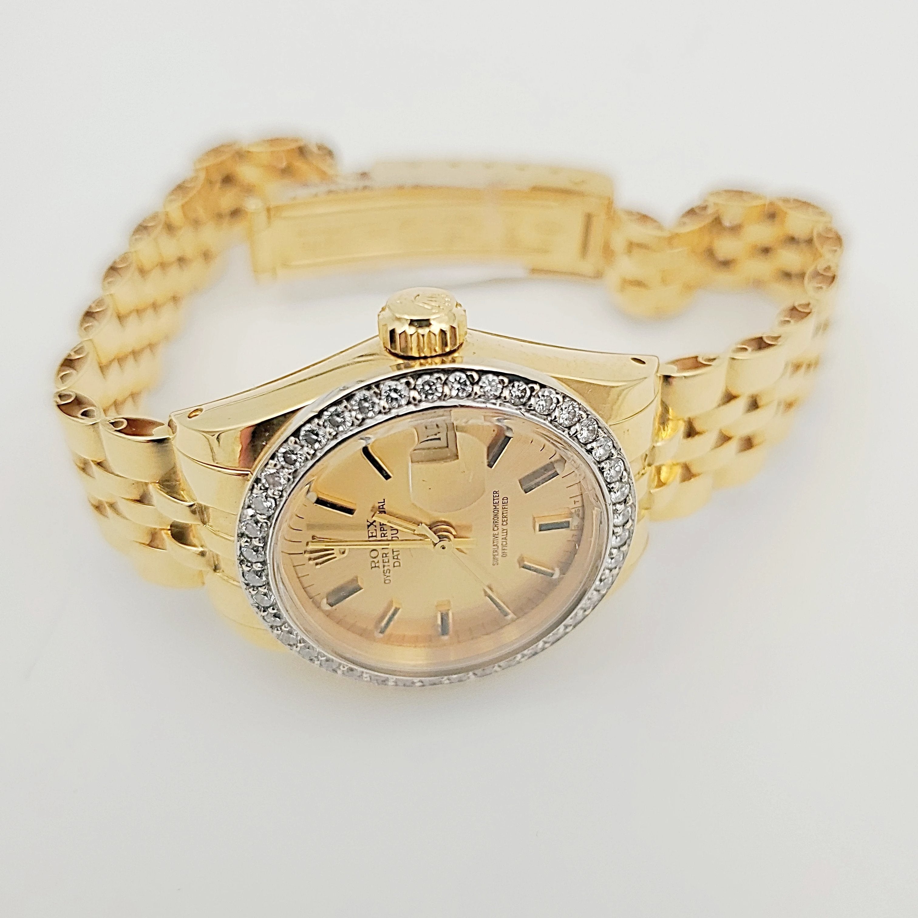 Ladies Rolex 26mm DateJust 18K Yellow Gold Watch with Champagne Dial and Custom Diamond Bezel. (Pre-Owned)