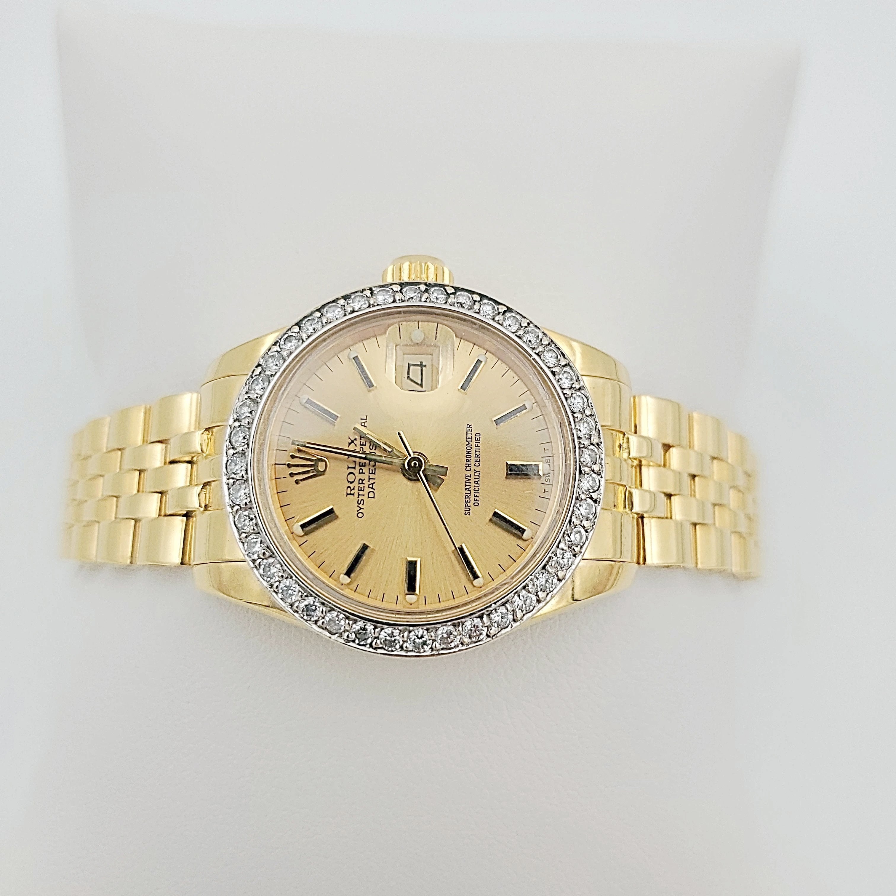 Ladies Rolex 26mm DateJust 18K Yellow Gold Watch with Champagne Dial and Custom Diamond Bezel. (Pre-Owned)