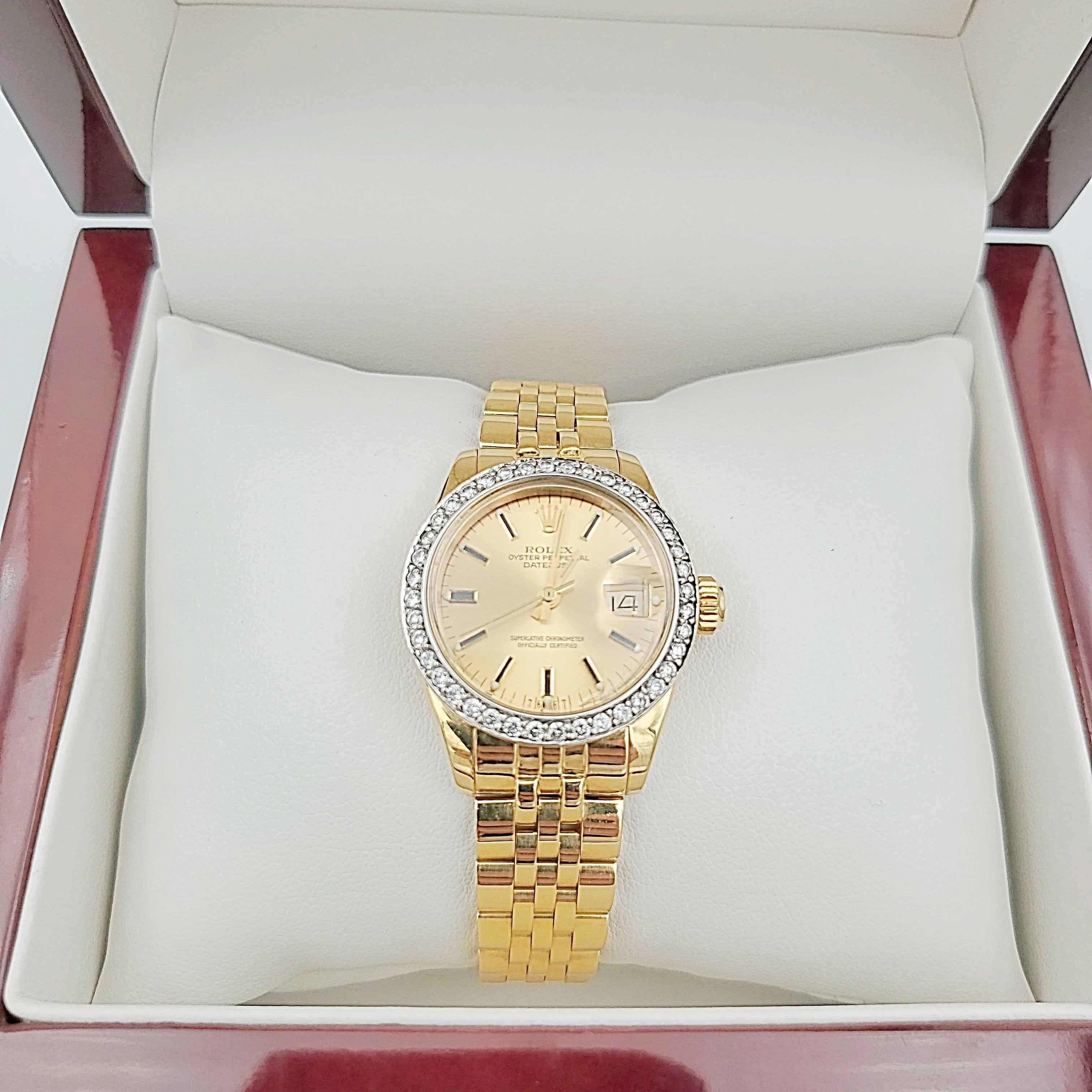 Ladies Rolex 26mm DateJust 18K Yellow Gold Watch with Champagne Dial and Custom Diamond Bezel. (Pre-Owned)