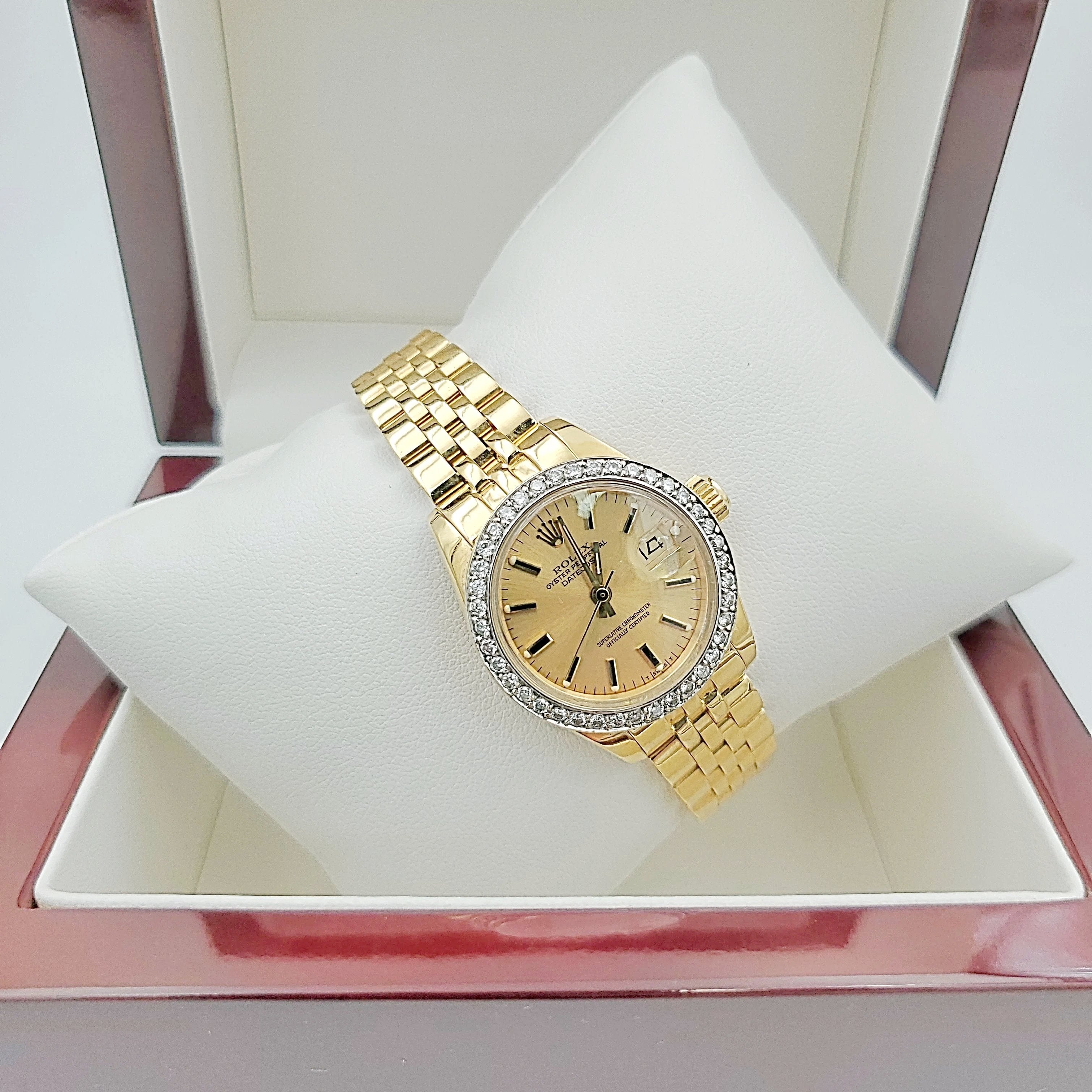 Ladies Rolex 26mm DateJust 18K Yellow Gold Watch with Champagne Dial and Custom Diamond Bezel. (Pre-Owned)