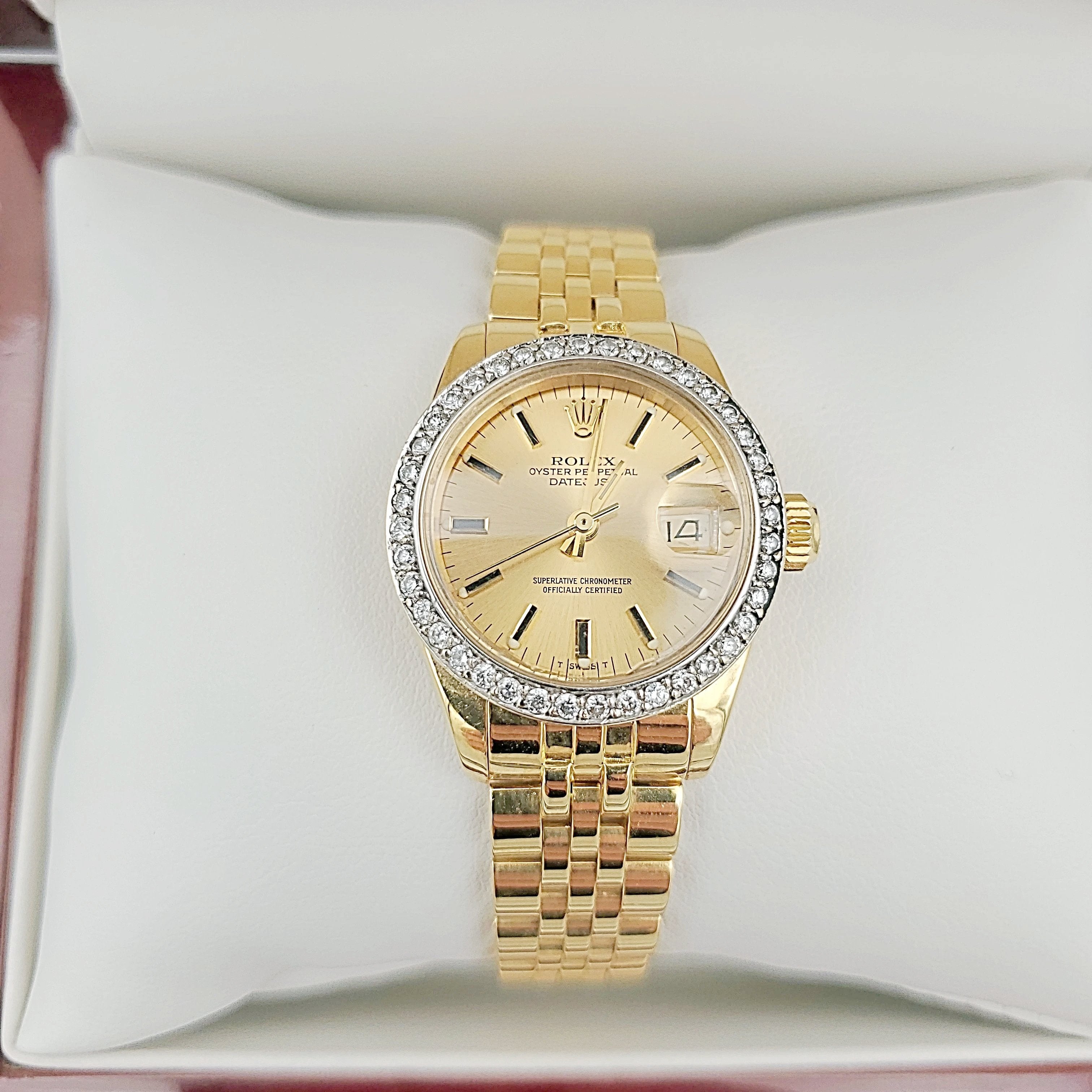 Ladies Rolex 26mm DateJust 18K Yellow Gold Watch with Champagne Dial and Custom Diamond Bezel. (Pre-Owned)