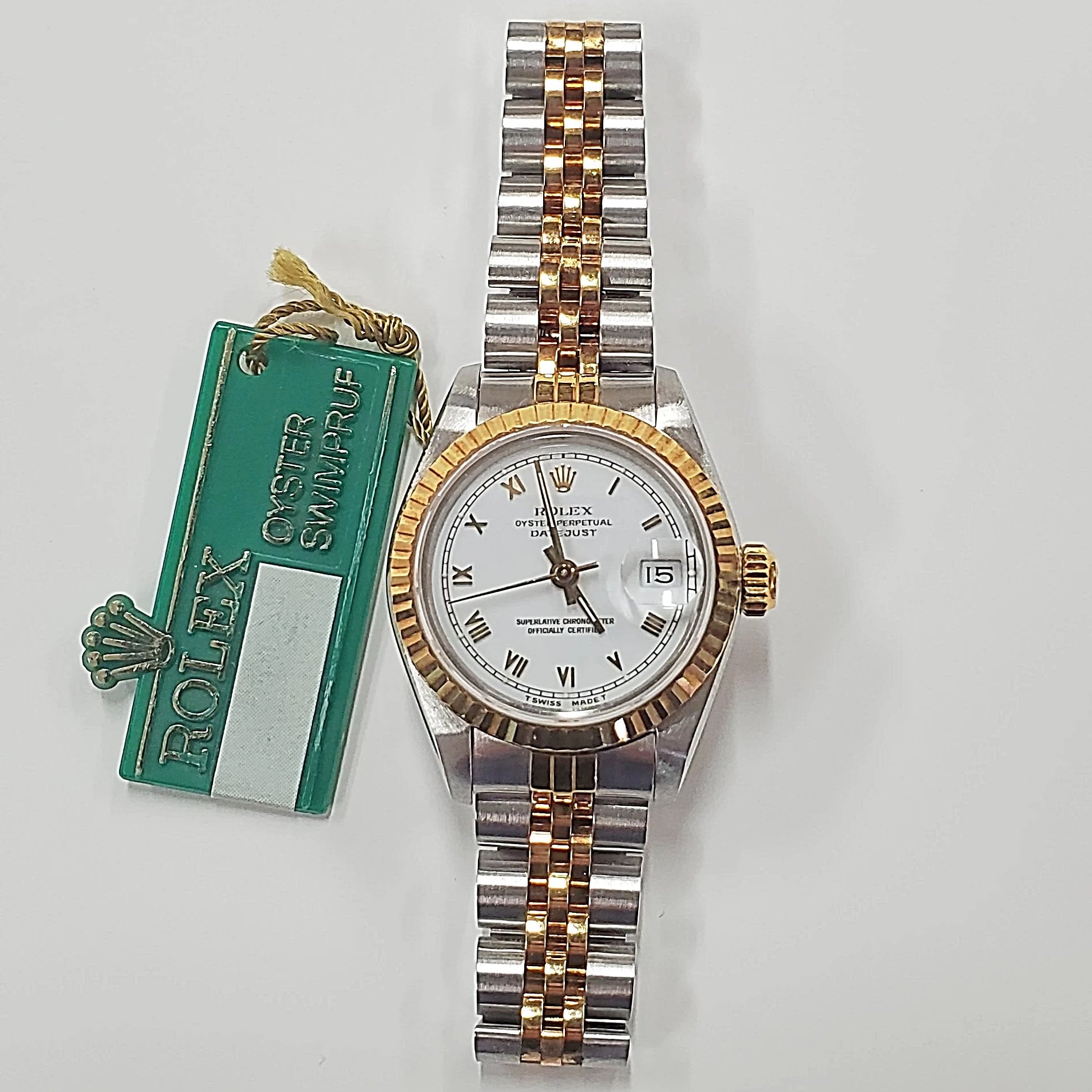 Ladies Rolex 26mm DateJust Two Tone 18K Gold Watch with White Dial, Fluted Bezel and Roman Numerals. (Pre-Owned)