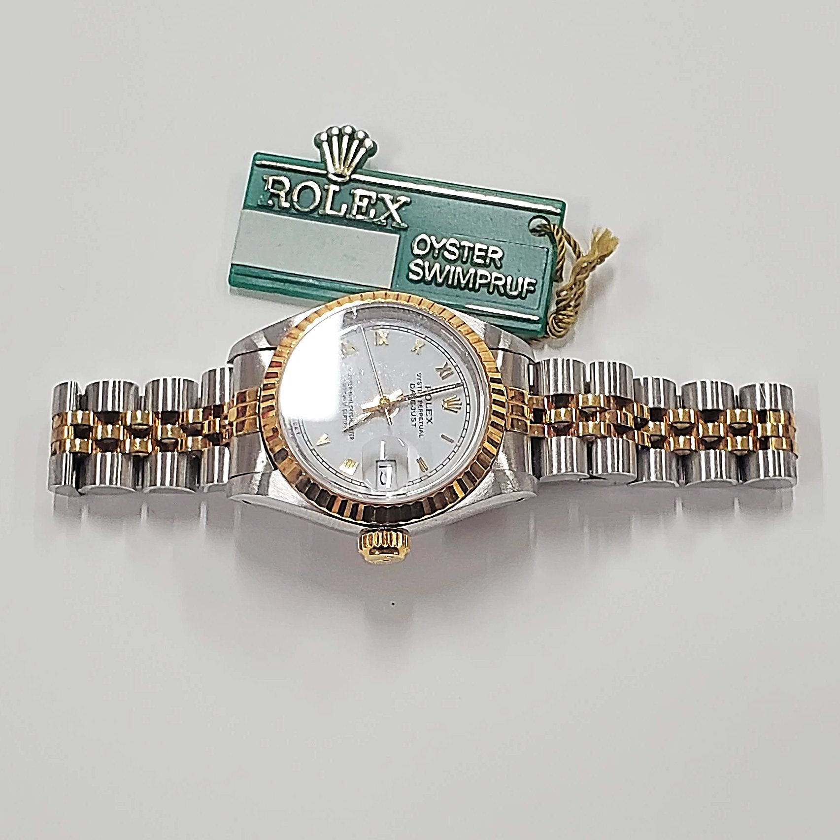 Ladies Rolex 26mm DateJust Two Tone 18K Gold Watch with White Dial, Fluted Bezel and Roman Numerals. (Pre-Owned)