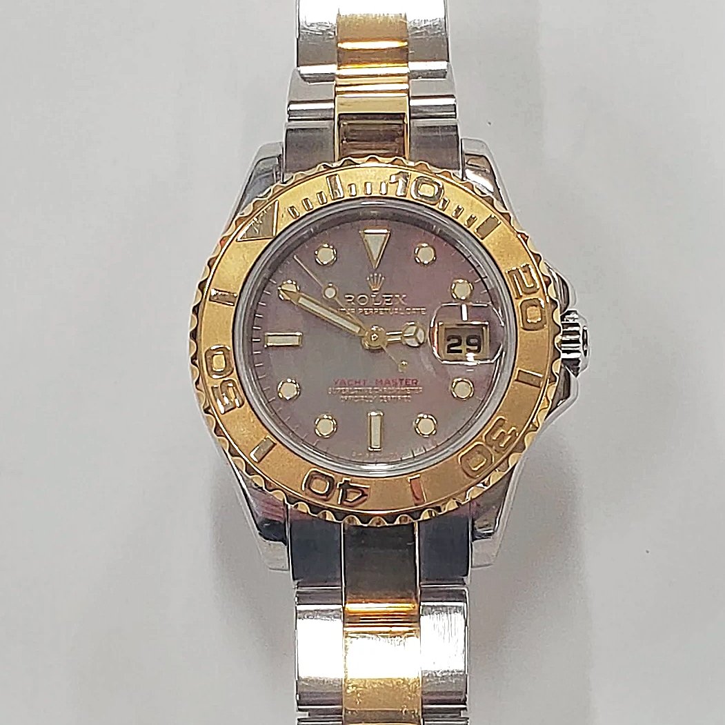 Ladies Rolex 29mm Two Tone 18K Gold Yachtmaster Watch with Black Mother of Pearl Dial and Rotatable Bezel. (Pre-Owned)