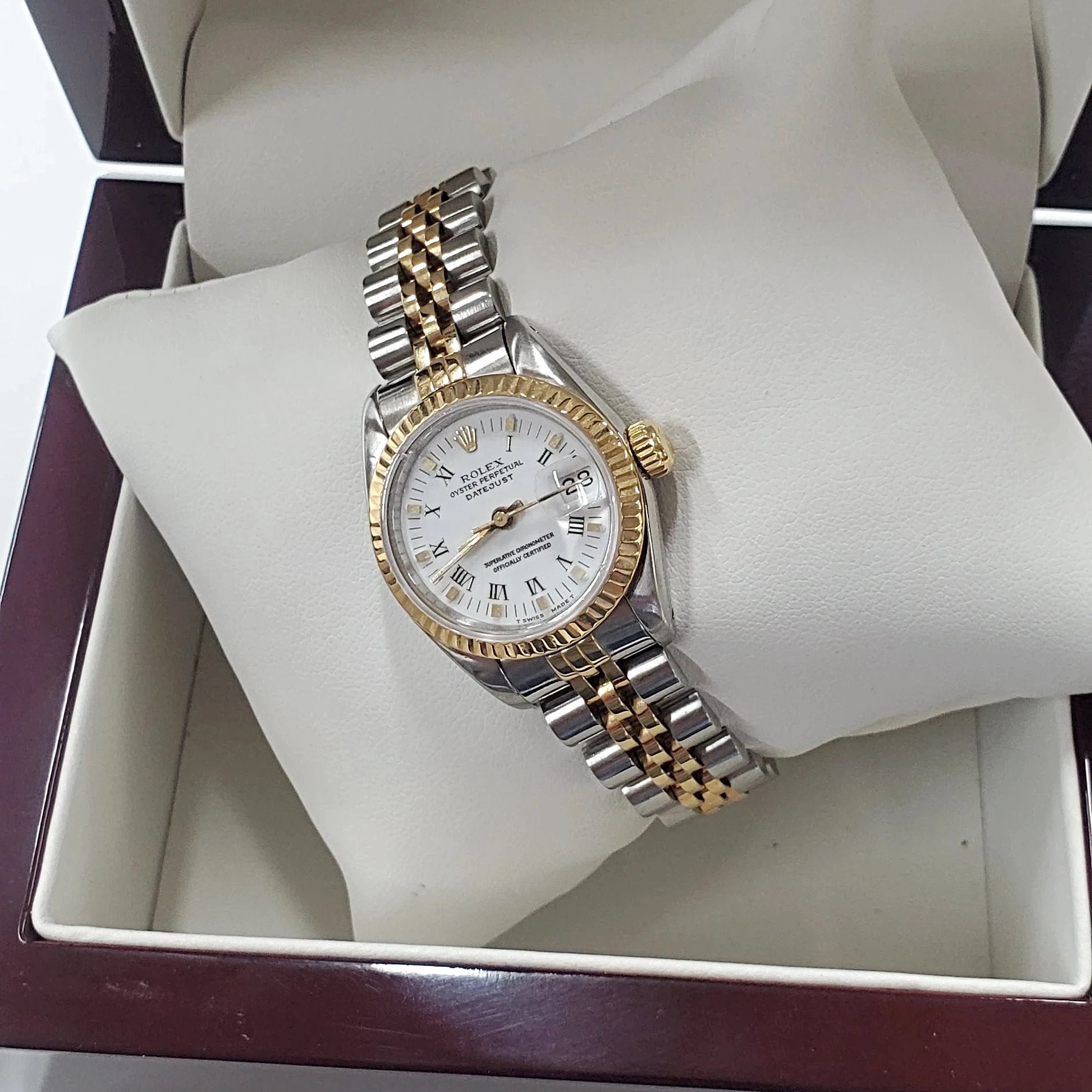 Women's Rolex 26mm DateJust Two-Tone 18K Gold Watch, with Fluted Bezel, White Dial, and Roman Numerals.