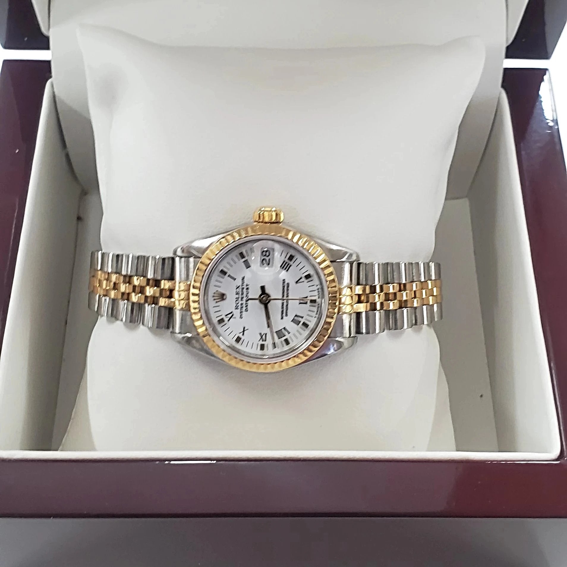 Ladies Rolex 26mm DateJust Two Tone 18K Gold Watch with Fluted Bezel, White Dial and Roman Numerals. (Pre-Owned)