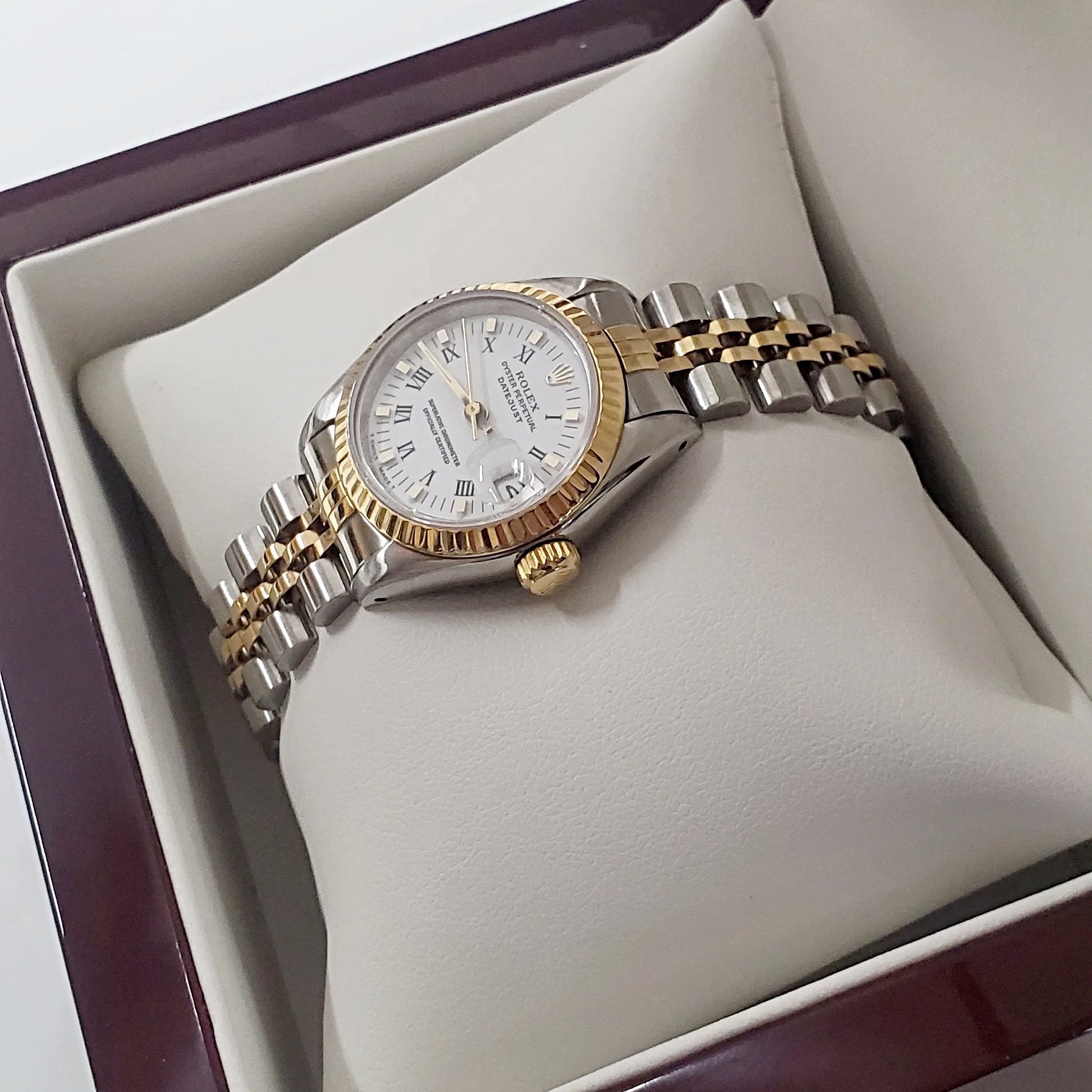 Ladies Rolex 26mm DateJust Two Tone 18K Gold Watch with Fluted Bezel, White Dial and Roman Numerals. (Pre-Owned)