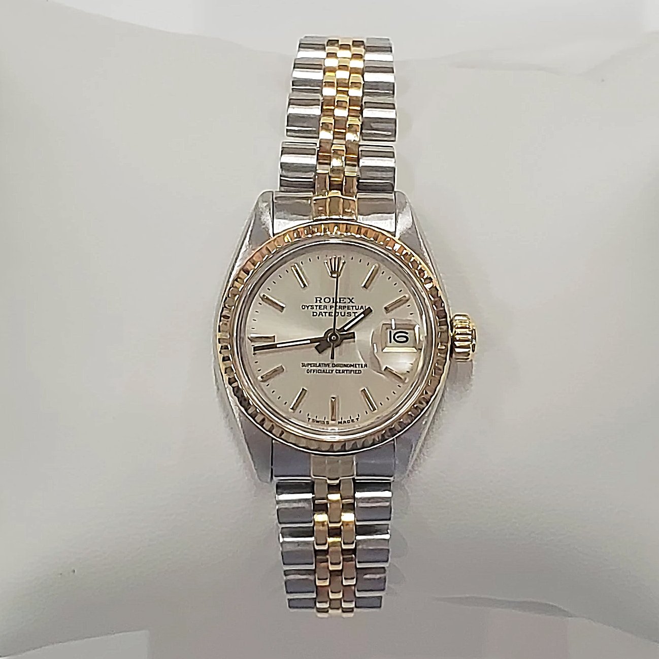 Ladies Rolex 26mm DateJust Two Tone 14K Yellow Gold / Stainless Steel Watch with Silver Dial and Fluted Bezel. (Pre-Owned)