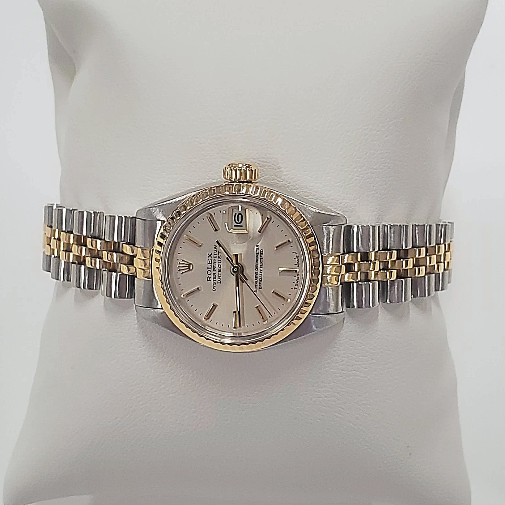 Ladies Rolex 26mm DateJust Two Tone 14K Yellow Gold / Stainless Steel Watch with Silver Dial and Fluted Bezel. (Pre-Owned)