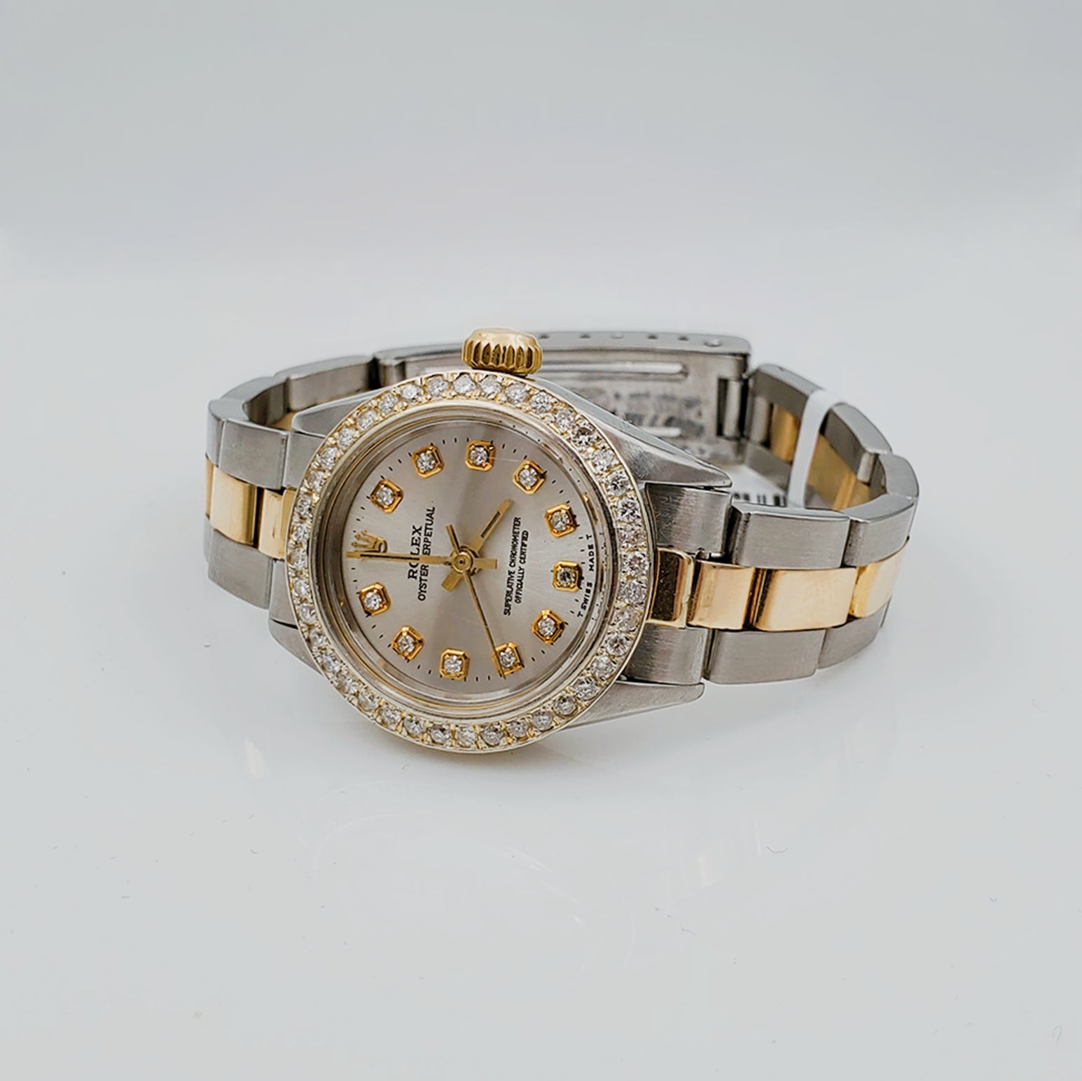 Ladies Rolex 26mm DateJust 18K Two Tone Watch with Silver Diamond Dial and Custom Diamond Bezel. (Pre-Owned)