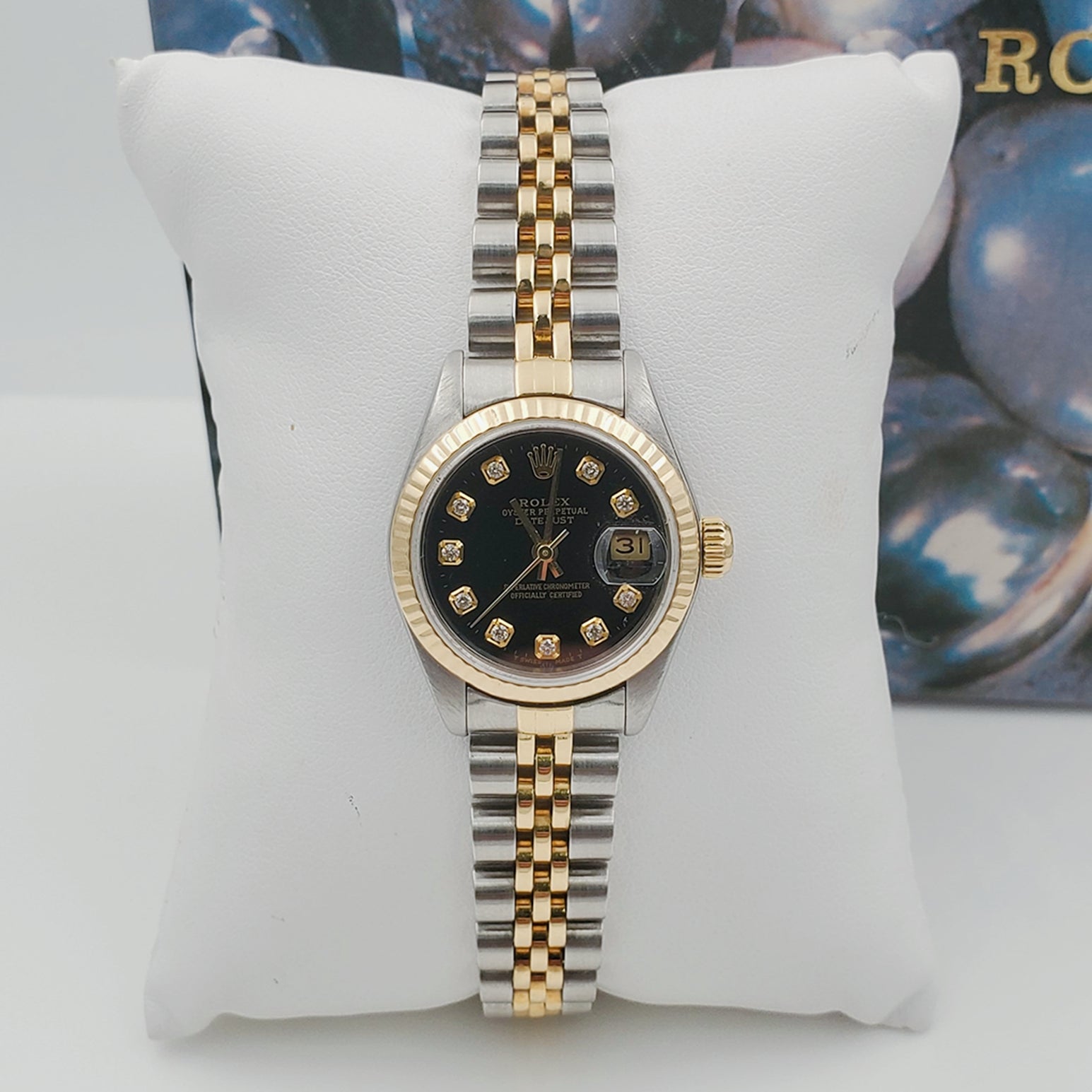 Ladies Rolex 26mm DateJust Two Tone 18K Yellow Gold / Stainless Steel Watch with Black Diamond Dial and Fluted Bezel. (Pre-Owned)