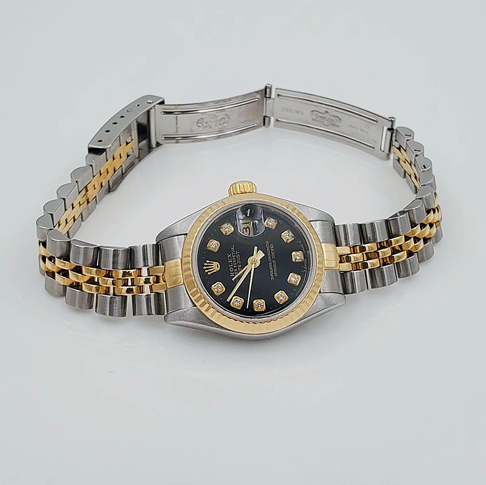 Ladies Rolex 26mm DateJust Two Tone 18K Yellow Gold / Stainless Steel Watch with Black Diamond Dial and Fluted Bezel. (Pre-Owned)