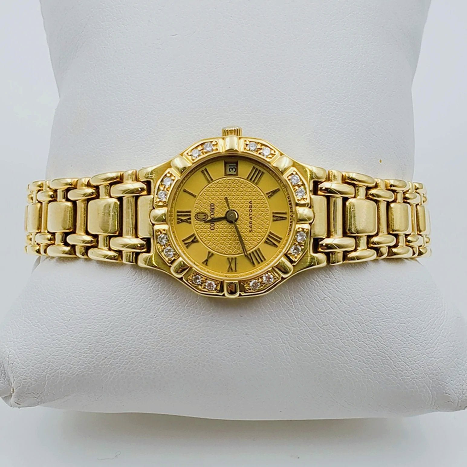 Ladies Concord Sarento 24mm Solid 18K Yellow Gold Band Watch with Roman Numeral Gold Dial and Diamond Bezel. (Pre-Owned)