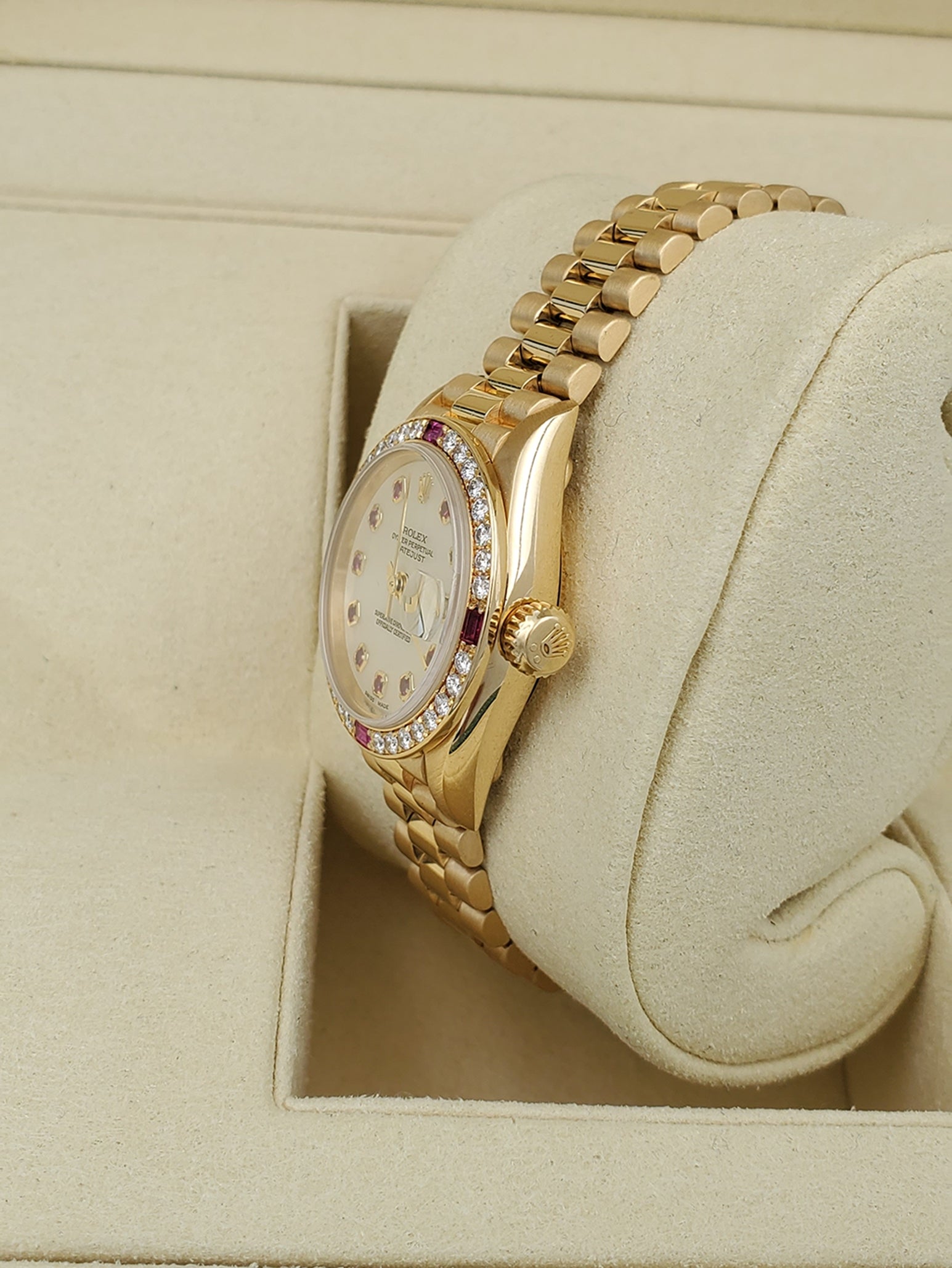 Ladies Rolex Presidential 26mm Solid 18K Yellow Gold Watch with Mother of Pearl Ruby Dial and Diamond Bezel. (Pre-Owned 7906B)