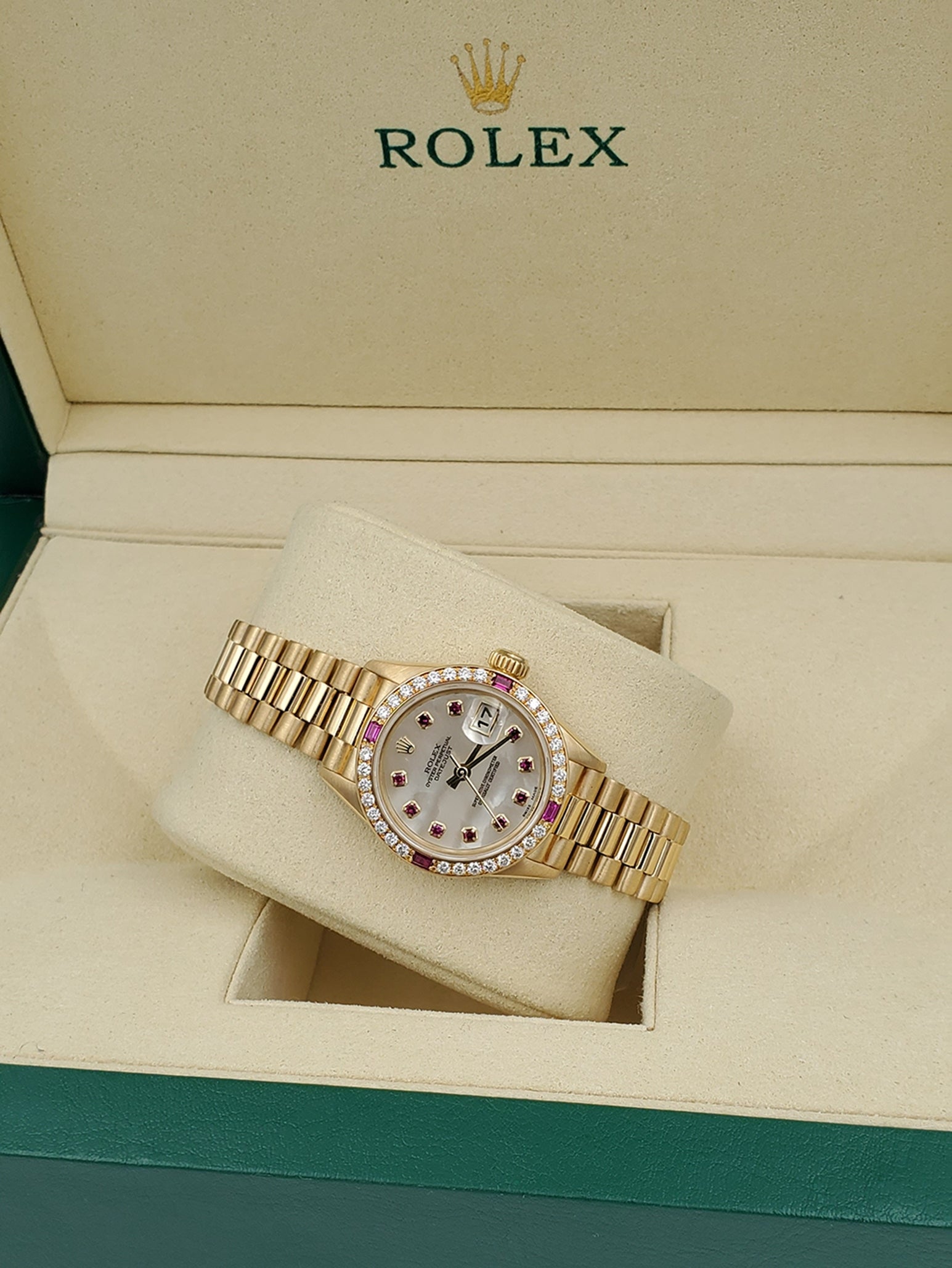 Ladies Rolex Presidential 26mm Solid 18K Yellow Gold Watch with Mother of Pearl Ruby Dial and Diamond Bezel. (Pre-Owned 7906B)