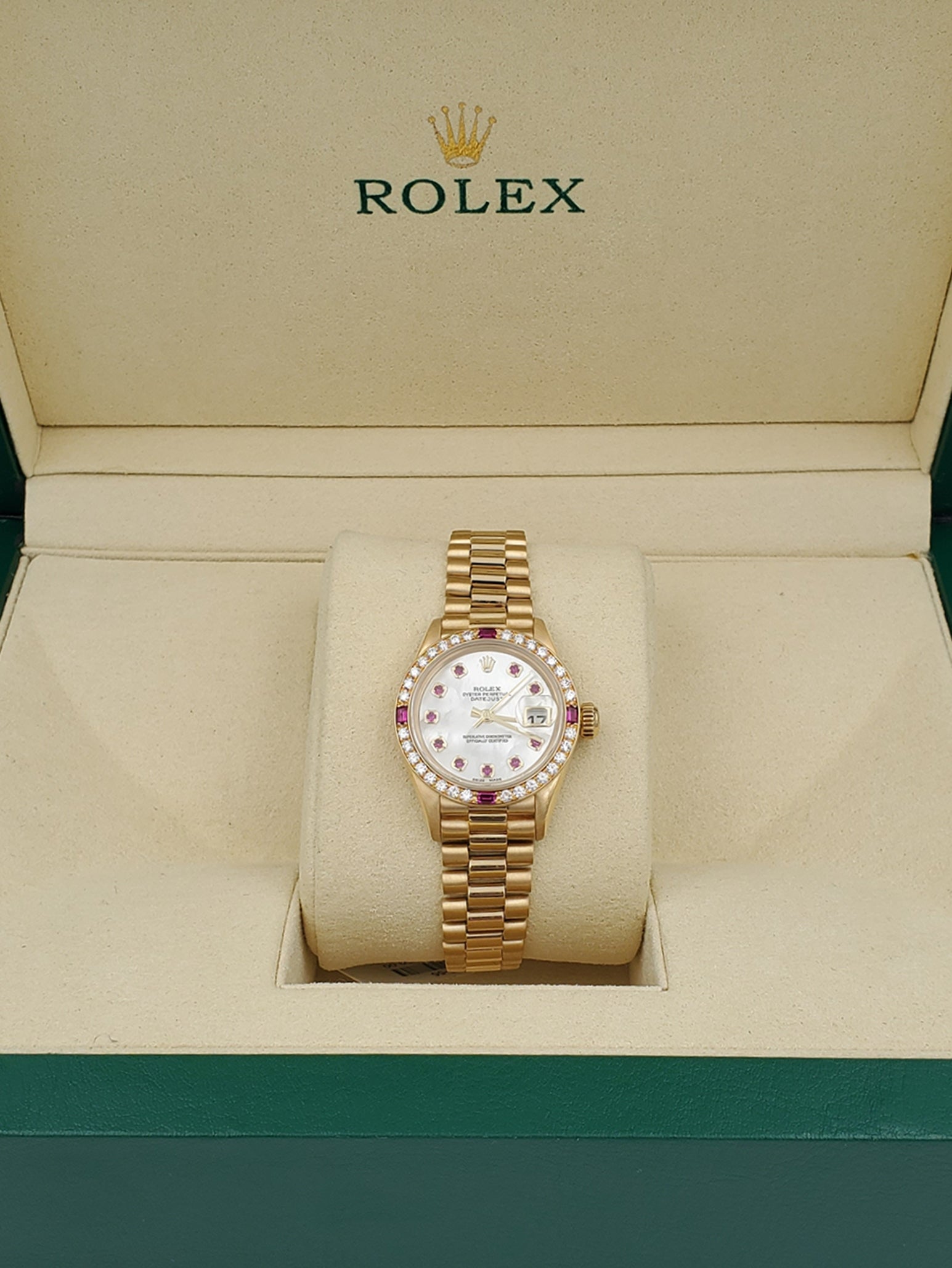 Ladies Rolex Presidential 26mm Solid 18K Yellow Gold Watch with Mother of Pearl Ruby Dial and Diamond Bezel. (Pre-Owned 7906B)