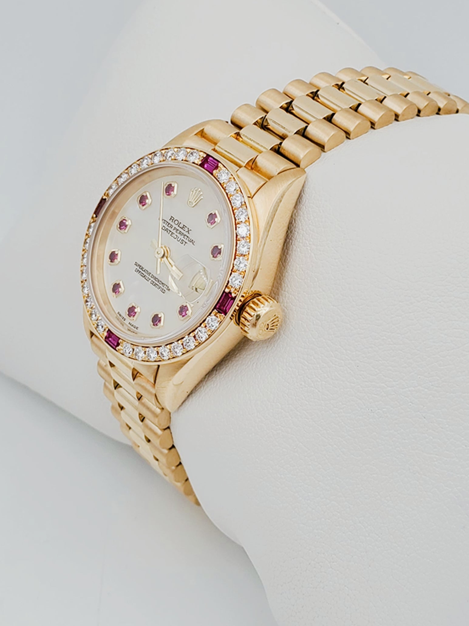 Ladies Rolex Presidential 26mm Solid 18K Yellow Gold Watch with Mother of Pearl Ruby Dial and Diamond Bezel. (Pre-Owned 7906B)