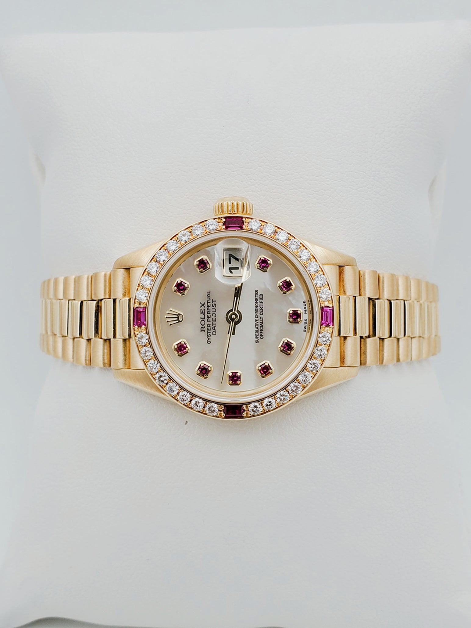 Ladies Rolex Presidential 26mm Solid 18K Yellow Gold Watch with Mother of Pearl Ruby Dial and Diamond Bezel. (Pre-Owned 7906B)