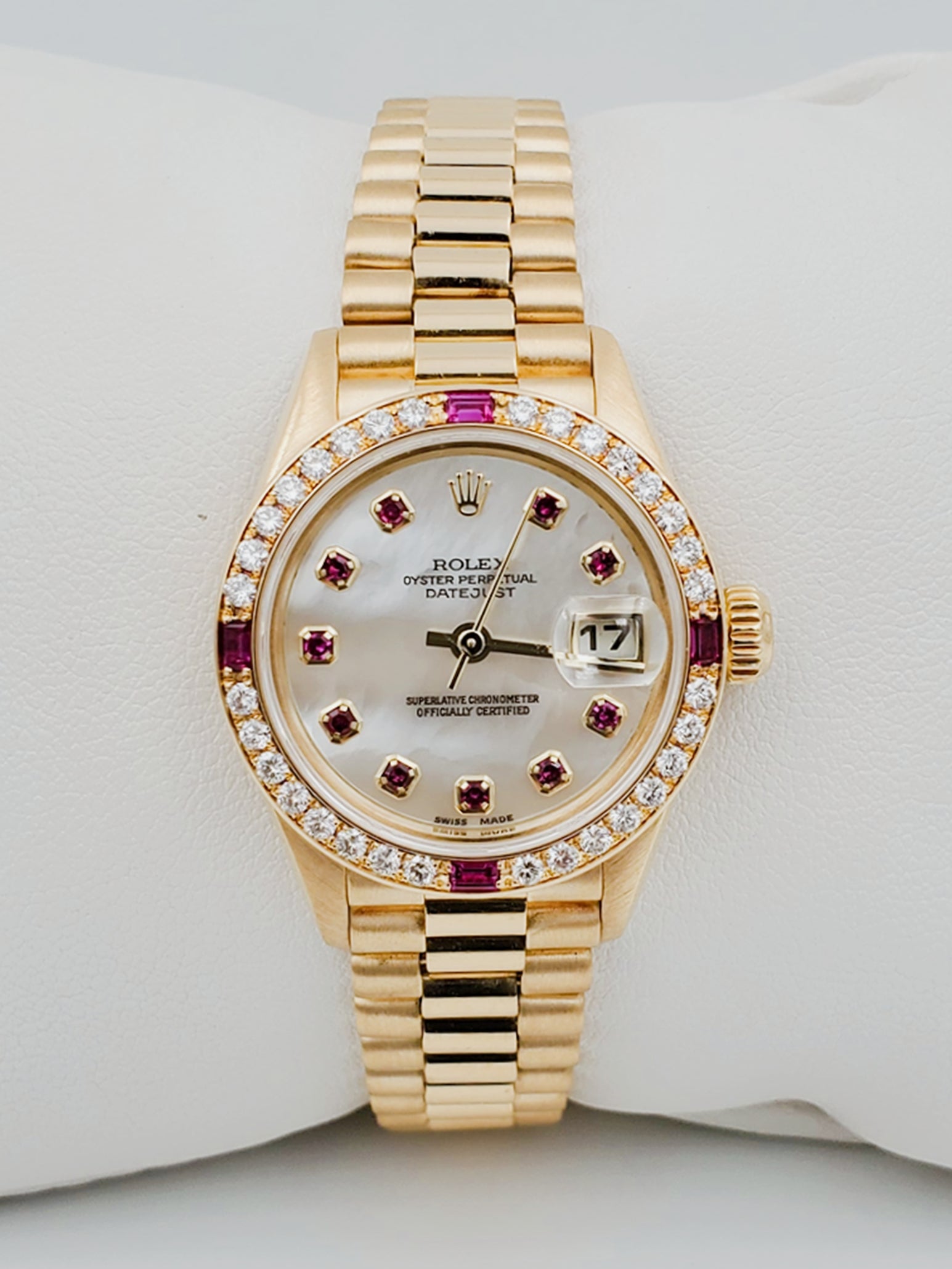 Ladies Rolex Presidential 26mm Solid 18K Yellow Gold Watch with Mother of Pearl Ruby Dial and Diamond Bezel. (Pre-Owned 7906B)