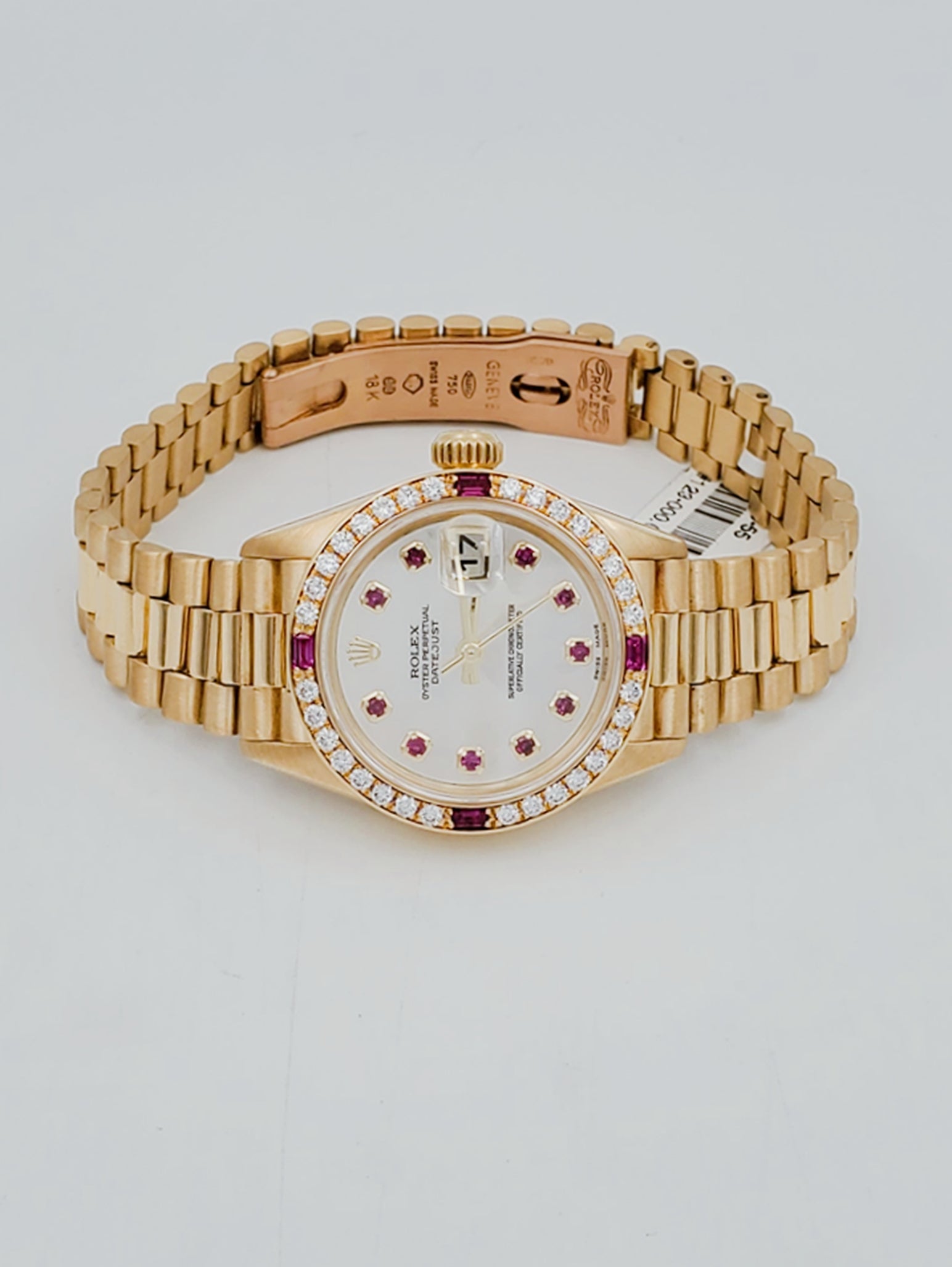 Ladies Rolex Presidential 26mm Solid 18K Yellow Gold Watch with Mother of Pearl Ruby Dial and Diamond Bezel. (Pre-Owned 7906B)