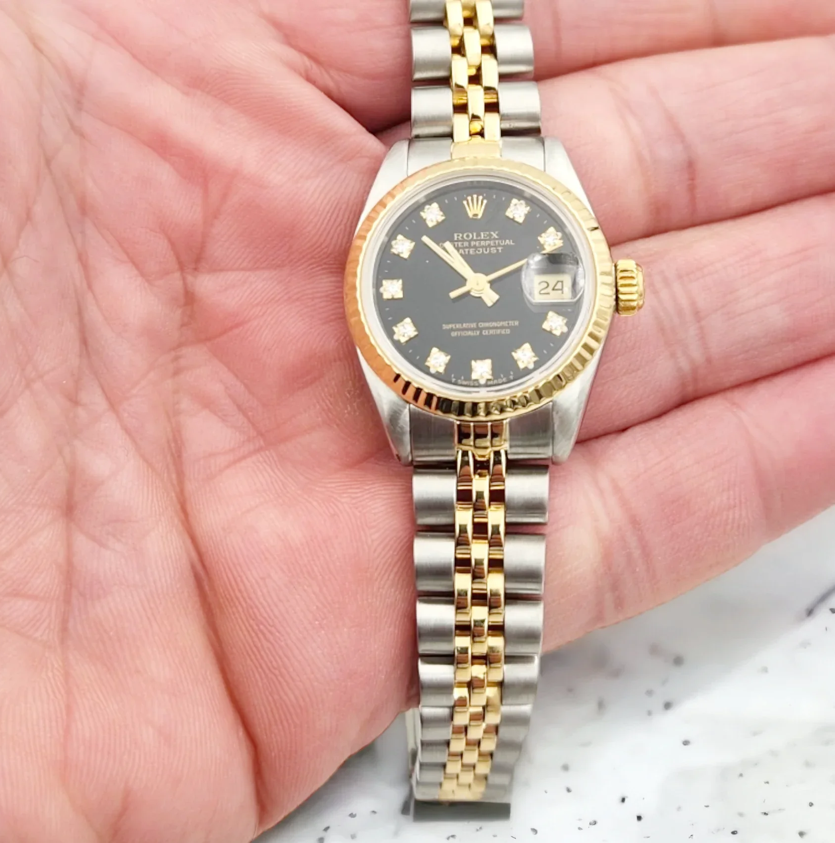 Ladies Rolex 26mm DateJust Two Tone 18K Yellow Gold / Stainless Steel Watch with Black Diamond Dial and Fluted Bezel. (Pre-Owned)