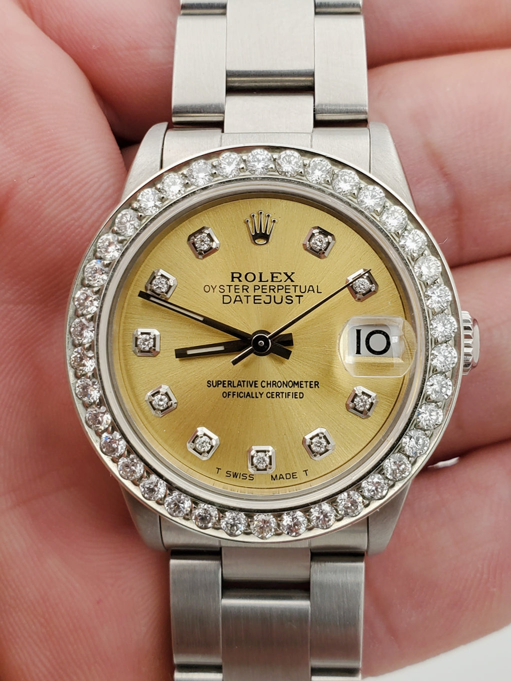 Ladies Midsize Rolex DateJust 31mm Stainless Steel Watch with Champagne Diamond Dial and Diamond Bezel. (Pre-Owned)